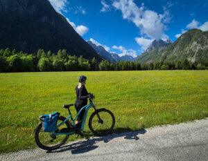 cyclist on the road in a green valley
